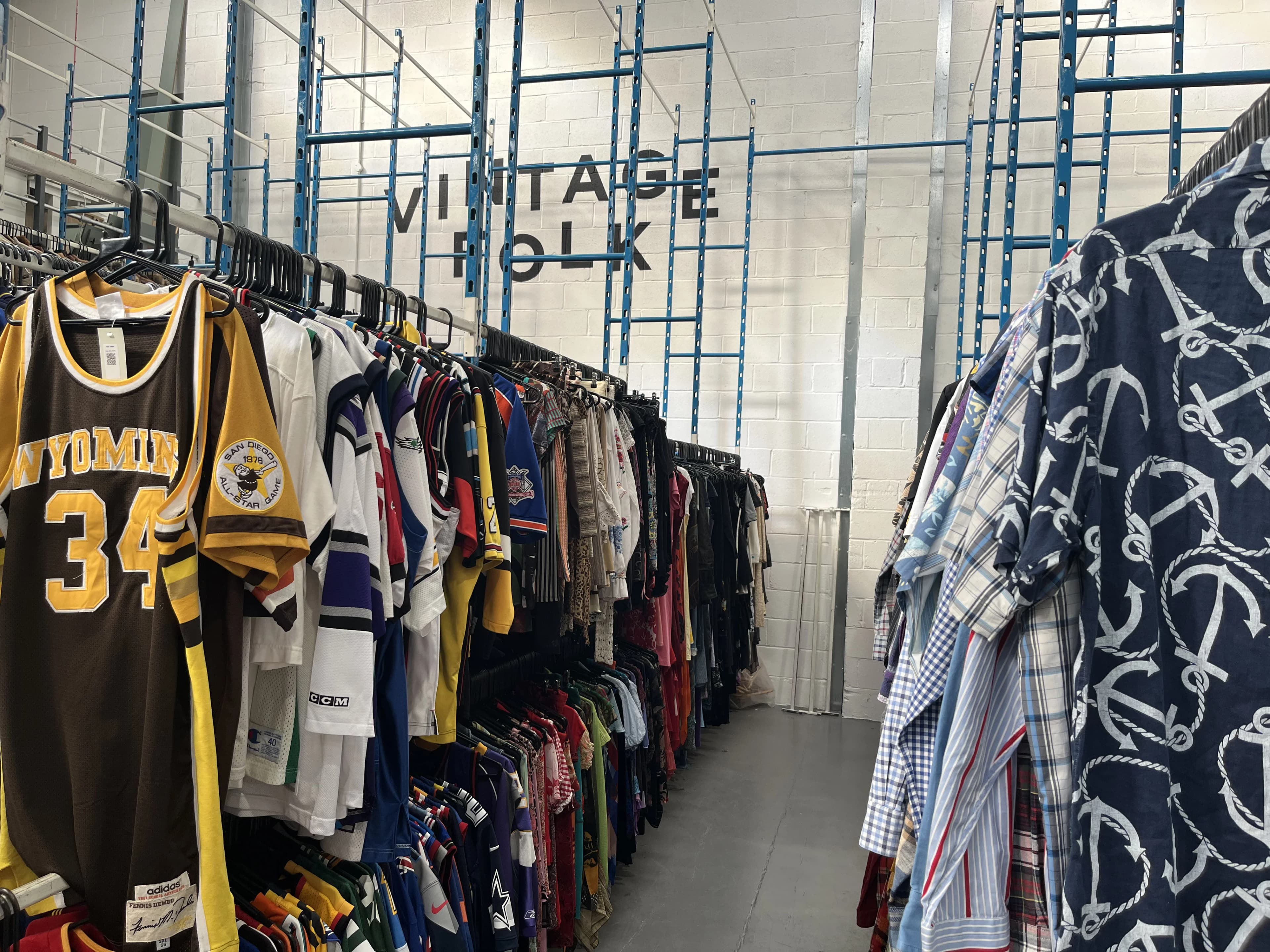 Rails of graded vintage clothing inside Vintage Folk's Manchester warehouse.
