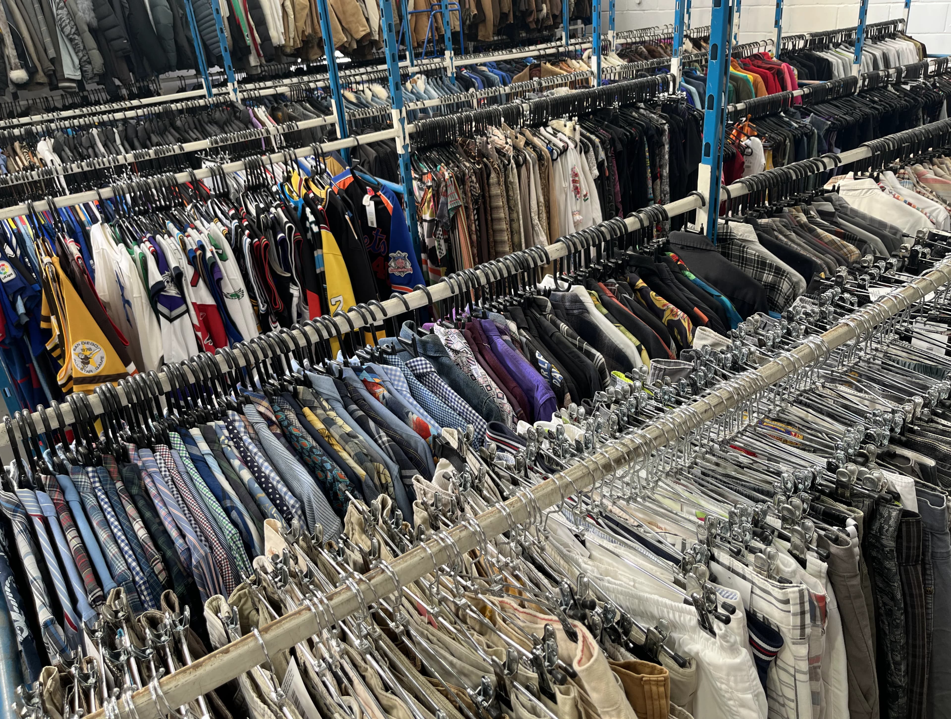 Rows of vintage clothing rails packed inside the Vintage Folk warehouse.
